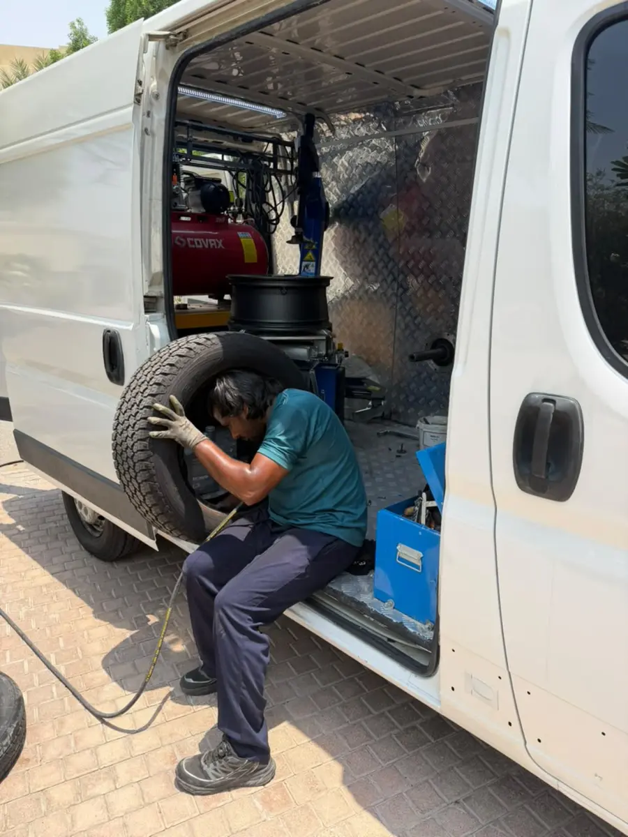 Onsite technician installing a tyre using mobile workshop equipment