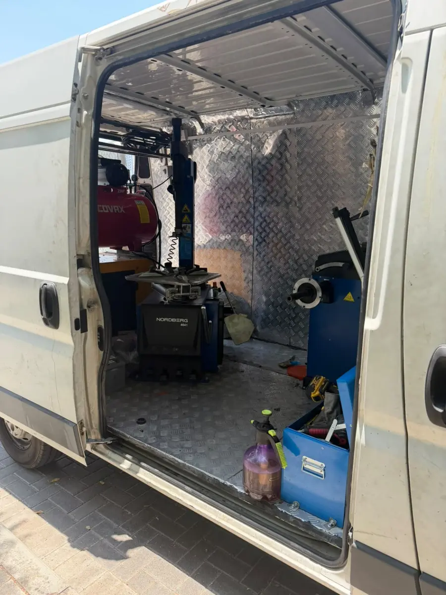 Tyre changer, wheel balancing equipment and compressor inside the mobile service van